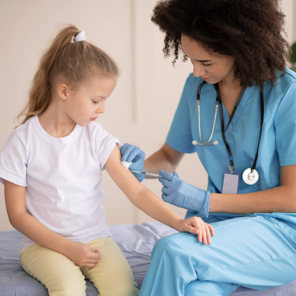 A smiling Geri Healthcare Solutions professional injecting a young kid.