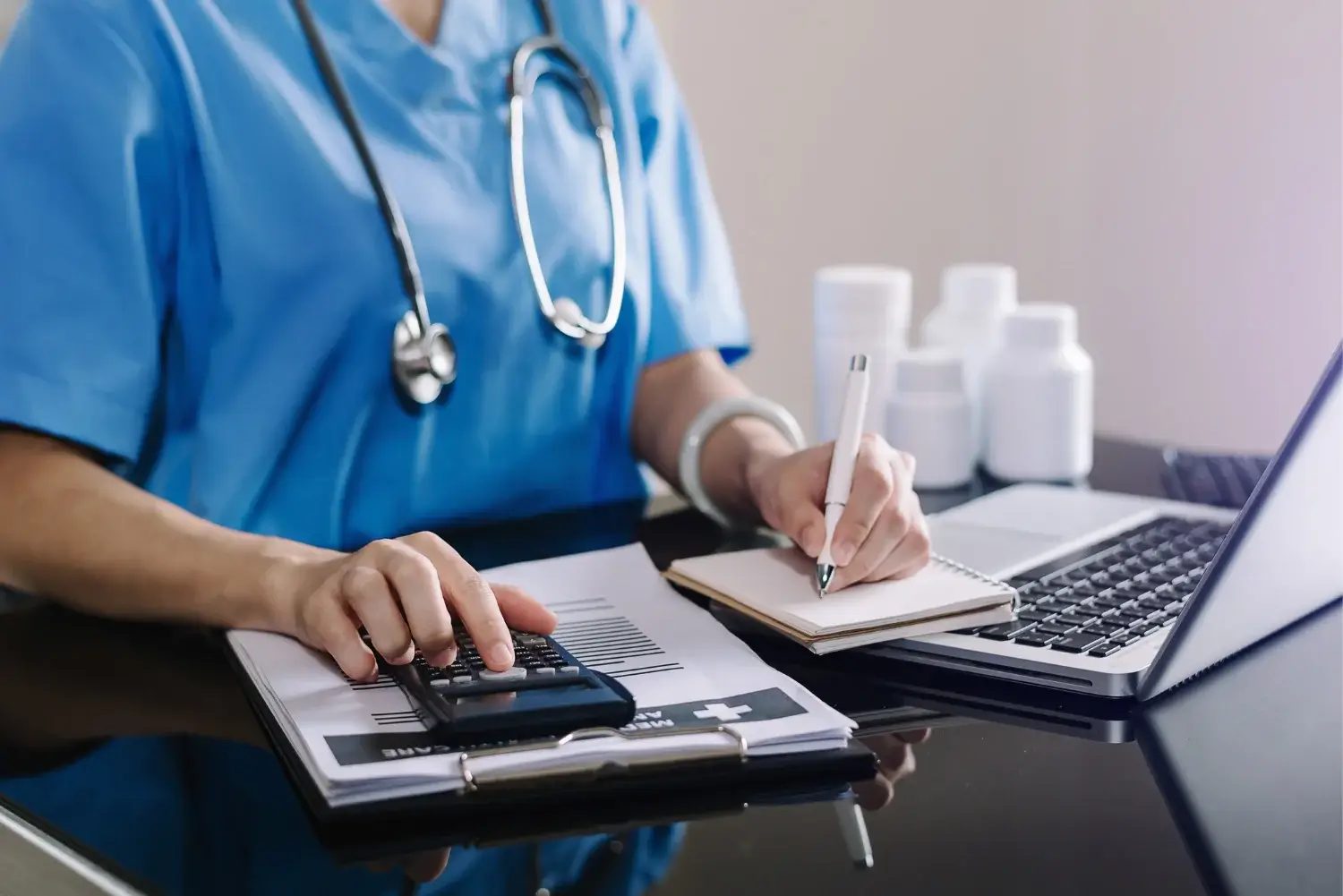 An expert from Geri Healthcare Solutions using a calculator to compute the cost of home care services.