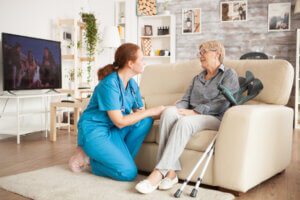 Senior receiving compassionate home care from a caregiver in a comfortable home environment.