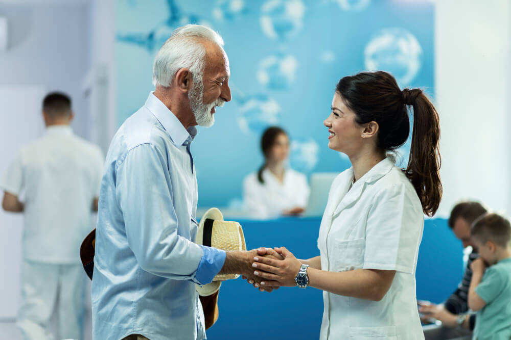 Temporary nurse speaking with permanent staff in a healthcare facility